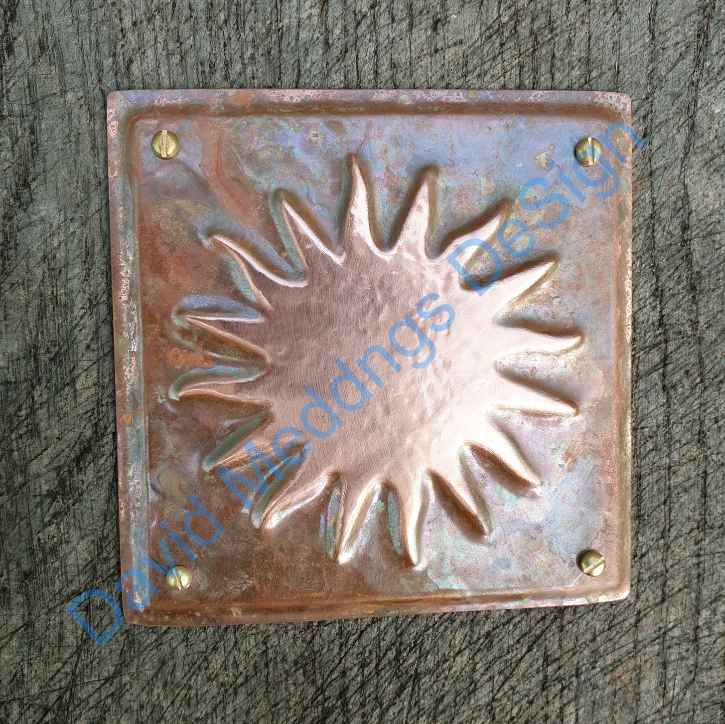 "Decorative copper embellishment plaque featuring a sun star design, representing solar astronomy, available in hammered or green copper finishes