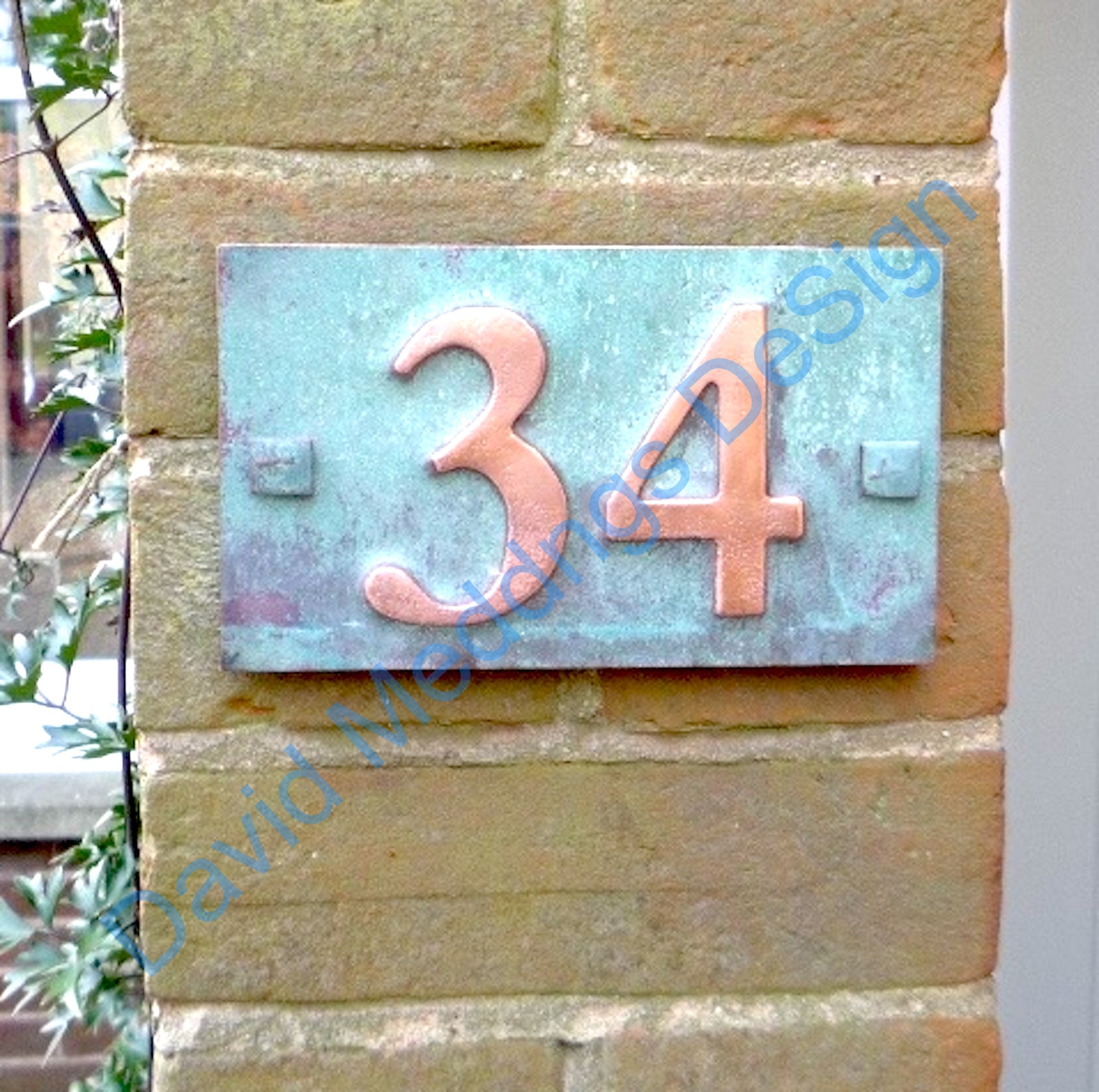 Traditional green copper plaque  on brick position