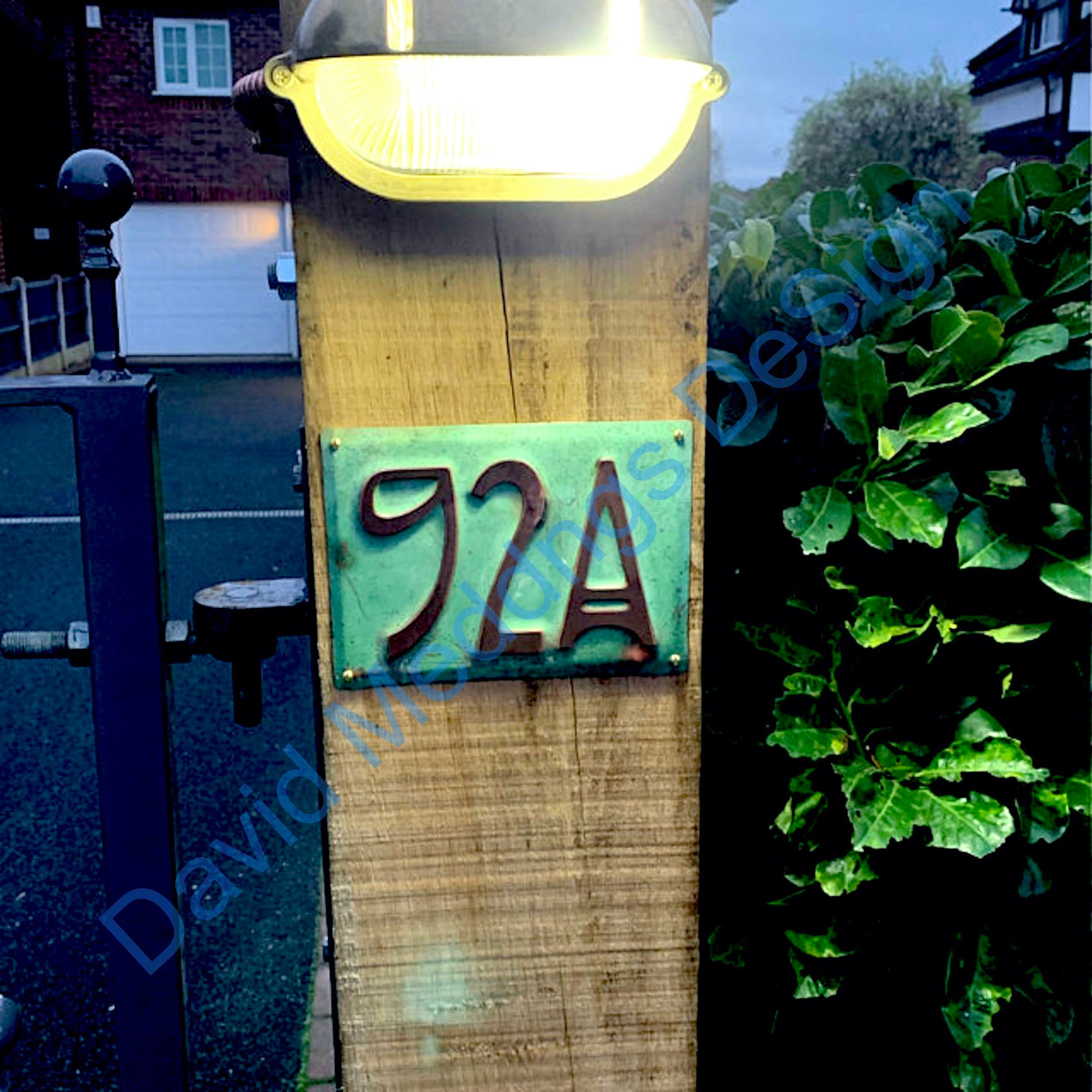 Art nouveau patinated copper plaque on post with light